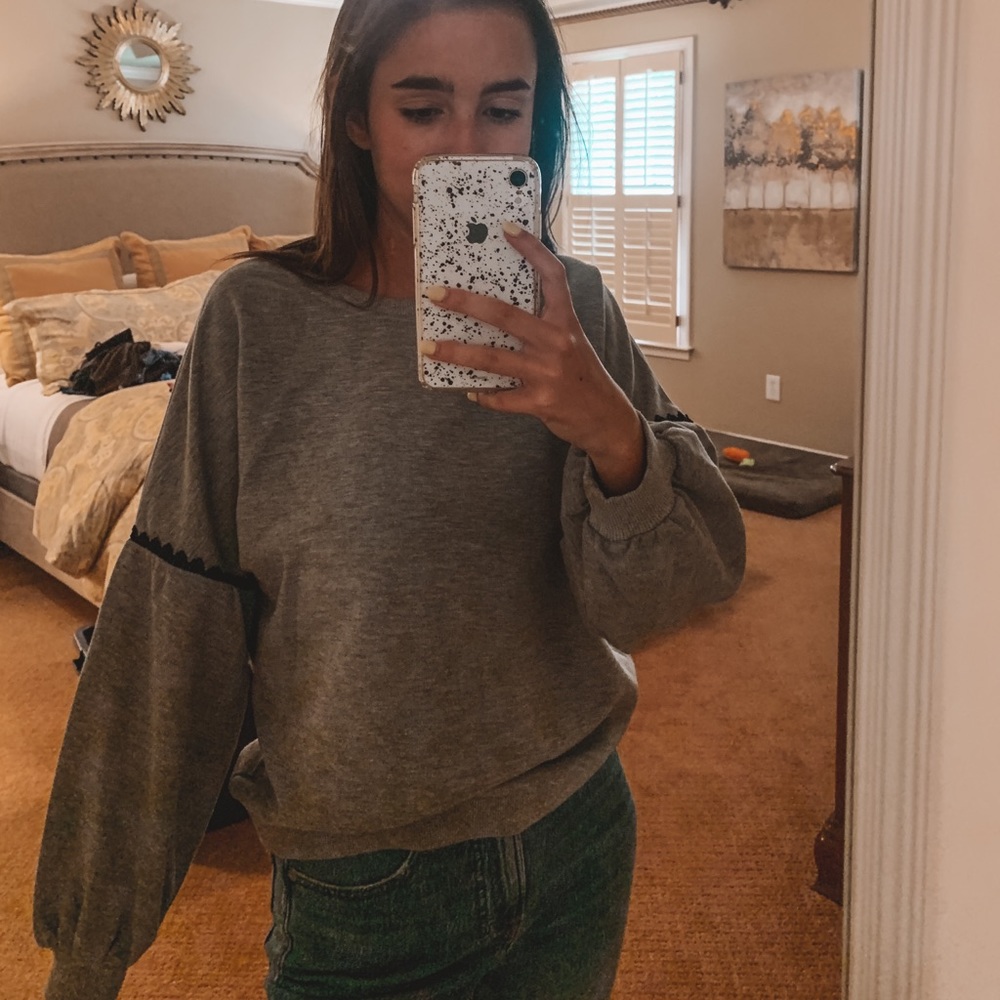 green sweater with cute black detail on sleeve